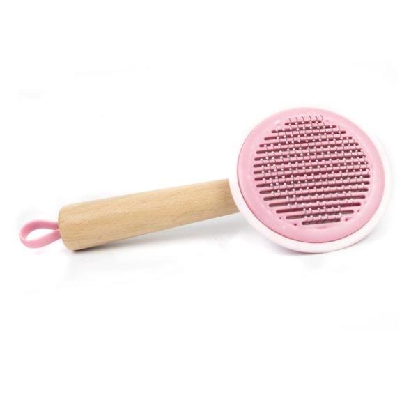 Imagen que muestra el producto Cepillo Bambú Para Mascotas. Cepillo de cabeza redonda con cerdas de metal, mango antideslizante y botón en la parte trasera para expulsar el pelo. Material: Metal, madera                                                                                                                       Color: Rosado, verde, amarillo.                                                                                                       Disponible: Razas pequeñas y medianas con pelaje largo.