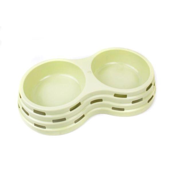 Imagen que muestra el producto Comedero Dos Compartimentos Para Mascotas. Comedero doble, cuenta con orificios en los costados. Material: Plástico    Color: Verde, rosado, azul                                                                                                Disponible: Razas pequeñas.  Medidas: Pequeño Largo 25,5 cm * Ancho 14 cm Alto 5 cm   Mediano: Largo 33,5 cm * Ancho 18cm Alto 6cm
