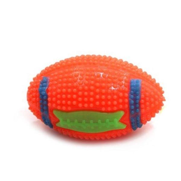 Imagen que muestra el producto Pelota Beisbol Chillona Para Mascotas. Juguete con diseño de pelota de futbol americano, cuenta con textura de púas, sonido y luz led interna. Material: Caucho                                                                                                      Color: Rosado, amarillo, azul, naranja, morado                                                                                   Disponible: Razas pequeñas y medianas.
